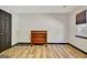 A traditional-style bedroom with wood floors and an antique wooden dresser at 401 Waterwood Bnd, Peachtree City, GA 30269