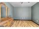 Bedroom with wood-look flooring and a dresser with ornate mirror at 401 Waterwood Bnd, Peachtree City, GA 30269