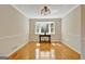 Dining room with natural light from the bay window and wood-look floors at 401 Waterwood Bnd, Peachtree City, GA 30269
