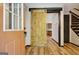 Inviting entryway with a barn door, wood floors, and a staircase to the upper level at 401 Waterwood Bnd, Peachtree City, GA 30269