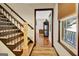 Entryway view showcasing staircase, modern wood floors, and decorative wood accents at 401 Waterwood Bnd, Peachtree City, GA 30269