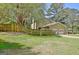 Side view of a two-story home with a two-car garage, wooden fence, and grassy yard at 401 Waterwood Bnd, Peachtree City, GA 30269