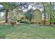 Charming home exterior with a cozy porch, well-maintained lawn, and lush landscaping at 401 Waterwood Bnd, Peachtree City, GA 30269