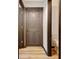 Hallway with wood floors featuring two closed doors to other rooms at 401 Waterwood Bnd, Peachtree City, GA 30269