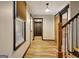 Bright hallway featuring wood floors, a window, and a wooden barn door at 401 Waterwood Bnd, Peachtree City, GA 30269