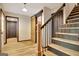 A beautiful foyer featuring hardwood flooring and a striking black iron staircase railing at 401 Waterwood Bnd, Peachtree City, GA 30269