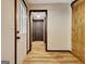 Bright hallway with wood floors featuring a barn door and open doorway at 401 Waterwood Bnd, Peachtree City, GA 30269