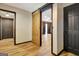 Hallway featuring wood floors, barn door, and doorways to other rooms at 401 Waterwood Bnd, Peachtree City, GA 30269