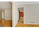 Hallway with wood-look floors and white trim provides a bright and airy feel at 401 Waterwood Bnd, Peachtree City, GA 30269