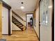 Bright hallway featuring wood floors, staircase, and doorway at 401 Waterwood Bnd, Peachtree City, GA 30269