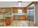 Beautiful kitchen with stainless appliances, stone accent wall, and wood cabinets at 401 Waterwood Bnd, Peachtree City, GA 30269