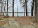Picnic table with lake view surrounded by mature trees and large rock outcroppings at 401 Waterwood Bnd, Peachtree City, GA 30269