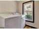 Bright laundry room with new washer and dryer next to a window at 401 Waterwood Bnd, Peachtree City, GA 30269