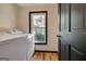 Laundry room with new washer and dryer next to window and closed door at 401 Waterwood Bnd, Peachtree City, GA 30269
