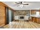 Cozy living room featuring a stone fireplace, wood-paneled walls, and a ceiling fan at 401 Waterwood Bnd, Peachtree City, GA 30269