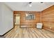 Inviting living room showcasing wood-paneled walls, and a decorative mirror at 401 Waterwood Bnd, Peachtree City, GA 30269