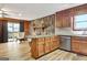 Open-concept kitchen and living room with stone fireplace and sliding glass door at 401 Waterwood Bnd, Peachtree City, GA 30269