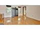 Open living room featuring wood floors, natural light, and neutral paint scheme at 401 Waterwood Bnd, Peachtree City, GA 30269