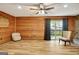 Bright living room with wood-paneled walls and fireplace, leading to outdoor patio at 401 Waterwood Bnd, Peachtree City, GA 30269