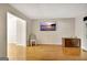Bright living room with hardwood floors, a mounted flat screen TV, and neutral walls at 401 Waterwood Bnd, Peachtree City, GA 30269