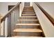 A lovely interior shot of a staircase with iron railing and hardwood steps at 401 Waterwood Bnd, Peachtree City, GA 30269