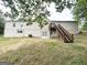 Backyard view featuring the exterior of the home and wooden deck stairs at 4397 Bluebird Ln, Lithia Springs, GA 30122
