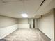 Finished basement space with neutral paint and carpeting and an additional storage area at 4397 Bluebird Ln, Lithia Springs, GA 30122