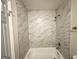 Bathroom featuring new tile in the shower and a tub at 4397 Bluebird Ln, Lithia Springs, GA 30122