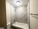 Updated bathroom features modern tiled shower and tub combination with updated fixtures at 4397 Bluebird Ln, Lithia Springs, GA 30122