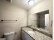Bathroom features a granite vanity, sink, toilet, mirror and tile shower at 4397 Bluebird Ln, Lithia Springs, GA 30122