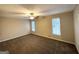 Bright bedroom featuring neutral walls, carpet, ceiling fan, and windows at 4397 Bluebird Ln, Lithia Springs, GA 30122