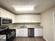 Well-lit kitchen features stainless steel appliances, stylish countertops and white cabinets at 4397 Bluebird Ln, Lithia Springs, GA 30122