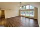 Bright living room features wood-look floors, a ceiling fan and large windows providing a great view at 4397 Bluebird Ln, Lithia Springs, GA 30122