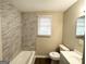 Updated bathroom with modern fixtures, tiled walls, and new flooring at 3332 Ruby H Harper Se Blvd, Atlanta, GA 30354
