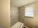 The bathroom has a bathtub with tiled shower and a window with blinds at 3332 Ruby H Harper Se Blvd, Atlanta, GA 30354