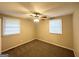 The bedroom features a ceiling fan, carpet and natural light at 3332 Ruby H Harper Se Blvd, Atlanta, GA 30354