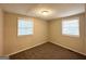 This bedroom offers carpeted floors, neutral-colored walls and two windows at 3332 Ruby H Harper Se Blvd, Atlanta, GA 30354
