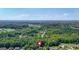 Aerial view of the home amidst a lush forest setting; property marked with a red locator pin at 127 Muirwood Dr, Temple, GA 30179