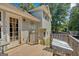 View of the wooden back deck with a glass door and staircase access to the grassy backyard area at 127 Muirwood Dr, Temple, GA 30179