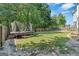 View of the expansive backyard with a trampoline, swing set, and bordering wooden fence at 127 Muirwood Dr, Temple, GA 30179