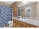 Bathroom featuring a vanity with light countertop, wood cabinets, and decorative shower curtain at 127 Muirwood Dr, Temple, GA 30179