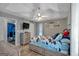 Bright bedroom with a ceiling fan, wood floors, and a decorative headboard at 127 Muirwood Dr, Temple, GA 30179