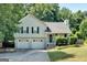 Charming two-story home with a two-car garage and a well-manicured lawn at 127 Muirwood Dr, Temple, GA 30179