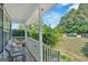 Cozy front porch with seating overlooking a lush green lawn and tree-lined street at 127 Muirwood Dr, Temple, GA 30179