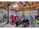 Garage with a quad, playhouse, exercise equipment, and multiple garage doors at 127 Muirwood Dr, Temple, GA 30179
