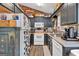 Compact kitchen with dark cabinets, stainless steel accents, and unique decorative touches at 127 Muirwood Dr, Temple, GA 30179