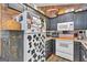 Kitchen features dark cabinets, a white range, and a refrigerator with a custom design at 127 Muirwood Dr, Temple, GA 30179