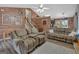 Comfortable living room with wood-look walls, ceiling fan, and cozy couches at 127 Muirwood Dr, Temple, GA 30179