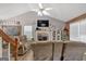 Bright and airy living room featuring a vaulted ceiling, fireplace, and lots of natural light at 127 Muirwood Dr, Temple, GA 30179
