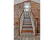 Staircase with decorative wood-look walls leading to the upper level at 127 Muirwood Dr, Temple, GA 30179